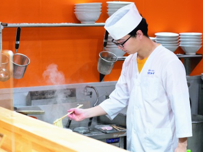 Enjoy watching the chefs prepare the ramen up close at the counter.