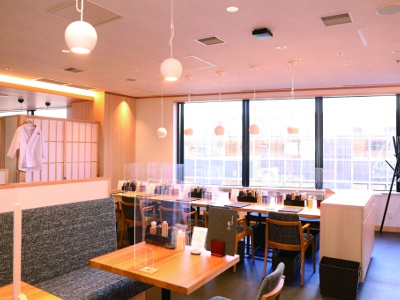 Bright and open interior. Various types of seating including counter seats, table seats, and private rooms.