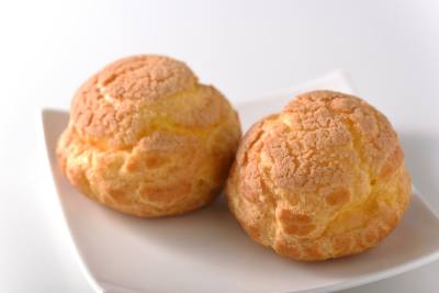 Cream puffs are popular among repeat customers. The dough is filled with rich custard and whipped cream.