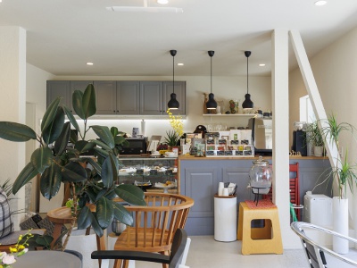 The interior, with its lovely color scheme, is bathed in light streaming through the large windows.