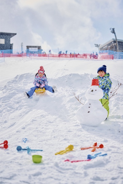 ロープウェイ山頂駅の目の前に広がるスノーランドで雪だるま作りにトライ！