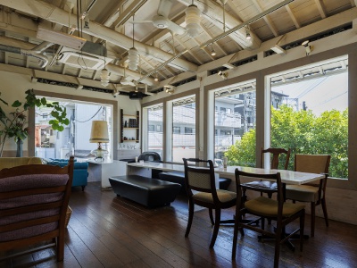 The store interior, where the greenery visible through the large, framed windows provides a soothing atmosphere.