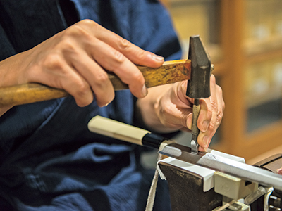 In all 3 stores, if there is a craftsman, you can engrave a name for free on the spot. It's a popular option because you can see the skill in front of you.