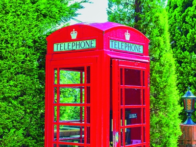A bright red telephone booth reminiscent of Europe.