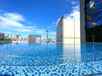 Infinity pool and Tsutenkaku seen from the roof terrace area.